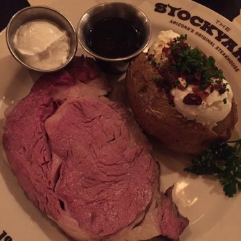 Stockyards Restaurant - 12 oz Cowboy Cut Best of the West Prime Rib with Loaded Baked Potato - Steakhouses Near Me - Phoenix, Arizona Stockyards Restaurant - 12 oz Cowboy Cut Best of the West Prime Rib with Loaded Baked Potato - Steakhouses Near Me - Phoenix, Arizona