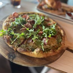 a pizza on a wooden board