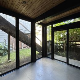 Floor-to-ceiling glass, slat wood paneling, and radiant heat flooring Floor-to-ceiling glass, slat wood paneling, and radiant heat flooring