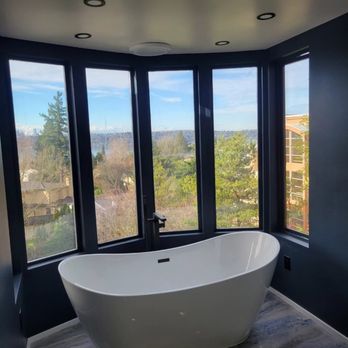 Rew Construction - a bathtub in the corner of a bathroom - Painters Near Me Rew Construction - a bathtub in the corner of a bathroom - Painters Near Me