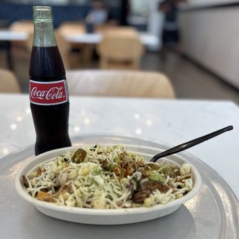 DosBros - Chicken and carnitas bowl with cilantro and lime white rice topped with guacamole, jalapeños, and cheese. - Tex-Mex Near Me - Orlando, Florida DosBros - Chicken and carnitas bowl with cilantro and lime white rice topped with guacamole, jalapeños, and cheese. - Tex-Mex Near Me - Orlando, Florida