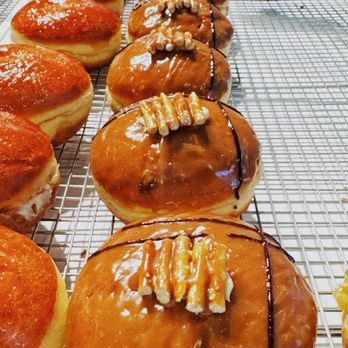Unholy Donuts - Salted Caramel Cheesecake: Filled with salted caramel cheesecake, topped with caramel ganache and pretzel antlers - Donuts Near Me - Toronto, Ontario
