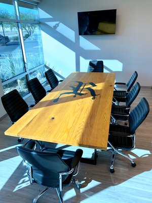 Royal Ink Conference Table - Royal Ink understands the power of branding. We helped show off their brand by engraving it into the middle of their custom 10ft conference table and then filling with a contrasting colored epoxy. Royal Ink Conference Table - Royal Ink understands the power of branding. We helped show off their brand by engraving it into the middle of their custom 10ft conference table and then filling with a contrasting colored epoxy.