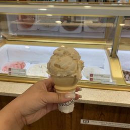 a hand holding a cone of ice cream a hand holding a cone of ice cream