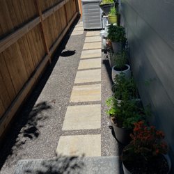 Zamora Landscaping - We transformed this side yard to make it more functional. By adding stepping stones and gravel.