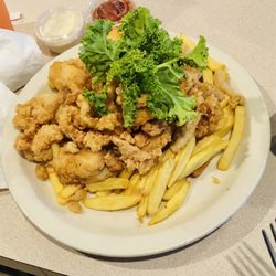 The Chowder House Restaurant - Daily special   Fried clams, grouper and shrimp. Served on a bed of fries with slaw on the side.