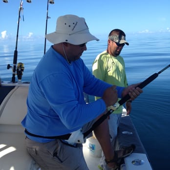 Neptuna Fishing Charters - Neptuna customer working on his fish - Fishing Near Me - Key West, Florida Neptuna Fishing Charters - Neptuna customer working on his fish - Fishing Near Me - Key West, Florida