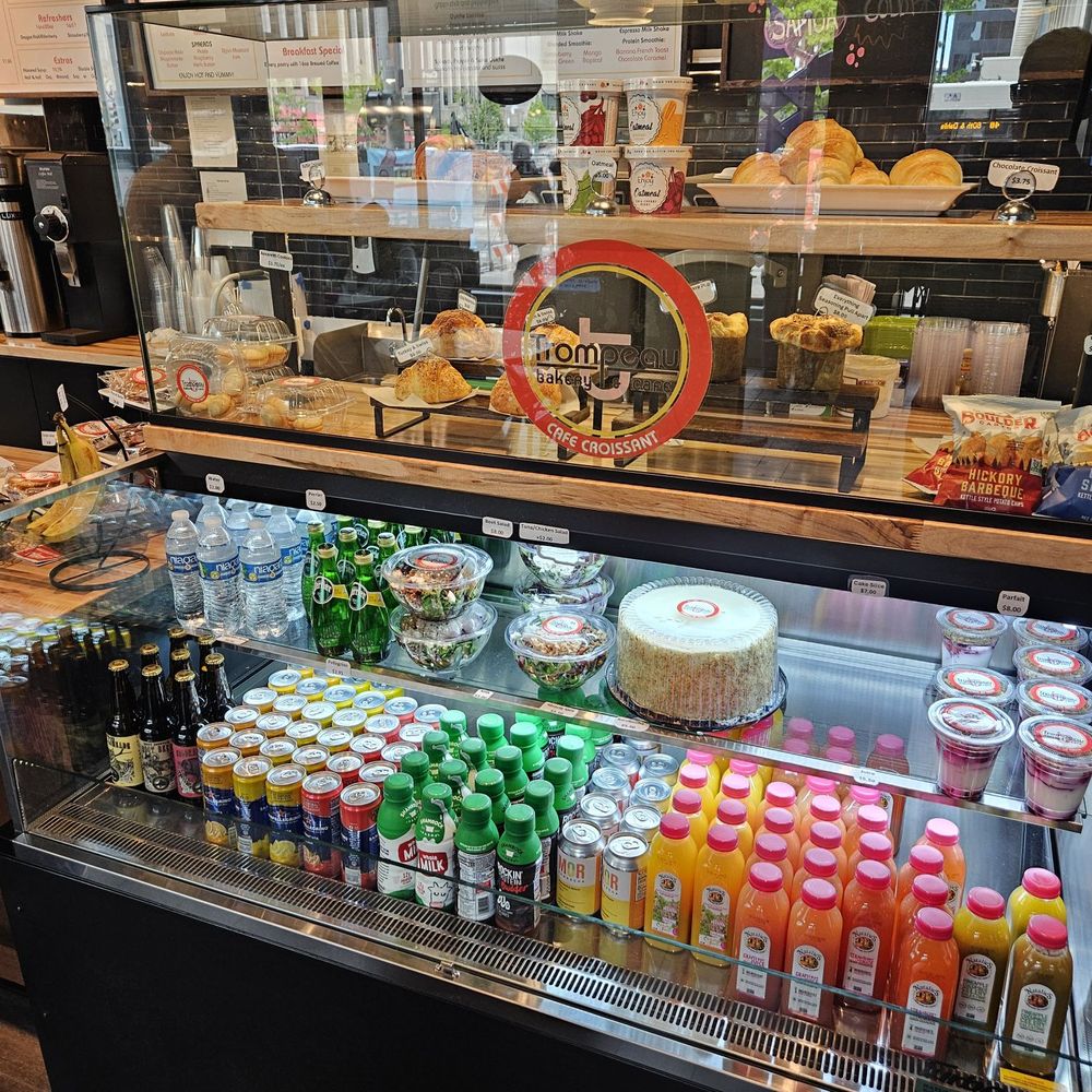 Trompeau Bakery - Cooler case with water, jombucha and juices with croissants in glass display - Bakeries Near Me - Denver, Colorado Trompeau Bakery - Cooler case with water, jombucha and juices with croissants in glass display - Bakeries Near Me - Denver, Colorado