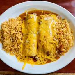 a plate of enchiladas and rice a plate of enchiladas and rice
