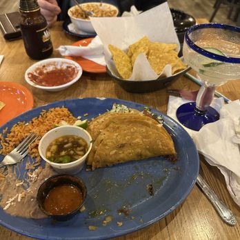 Jalapenos - Goood food great waiter! - A Mexican dish featuring tacos, rice, beans, and salsa on a blue plate, with drinks and chips on the table. - Mexican Near Me - Schereville, Indiana