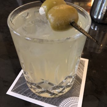 Beau Nash - a cocktail with a green olive garnish - Lounges Near Me - Dallas, Texas