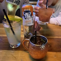 two people sitting at a table with drinks