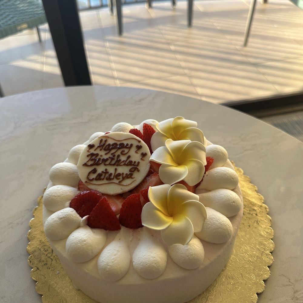 Custom Rainbow cake with strawberries and plumeria flowers. Custom Rainbow cake with strawberries and plumeria flowers.