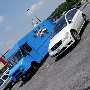 Wilde Thyme - a blue food truck and a white car - Food Trucks Near Me Wilde Thyme - a blue food truck and a white car - Food Trucks Near Me