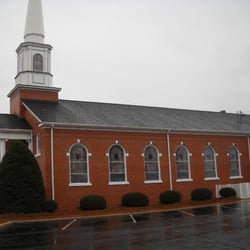 Roof Doctor - The Blue Metal Roof made the Stain Glass Windows of this Church Beautiful!