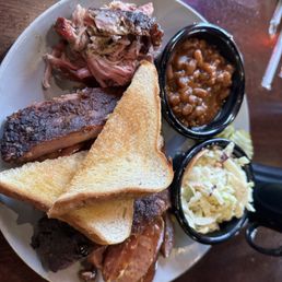 a plate of ribs, beans, and coleslaw a plate of ribs, beans, and coleslaw