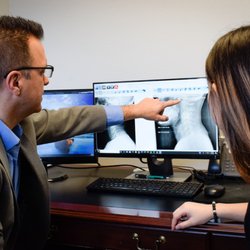 Spinal Rehab Specialists - Examination of a patient's injuries and discussion with patient.