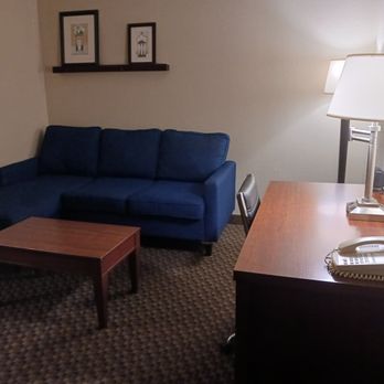 Comfort Suites Columbia Gateway - Living room area with couch and coffee table, desk and TV opposite couch. - Hotels Near Me - Elkridge, Maryland Comfort Suites Columbia Gateway - Living room area with couch and coffee table, desk and TV opposite couch. - Hotels Near Me - Elkridge, Maryland
