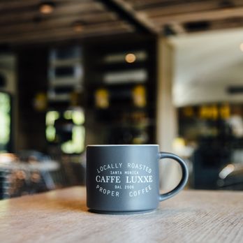 Caffe Luxxe - a coffee cup on a table - Coffee & Tea Near Me - Malibu, California