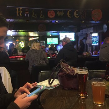 Timbers - a woman looking at her cell phone - Sports Bars Near Me - De Forest, Wisconsin