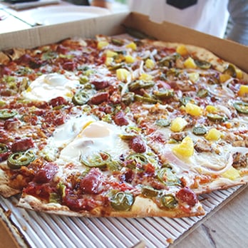 East Side Pies - half Old 97s with fried egg, half Jamaican - Pizza Near Me - Austin, Texas