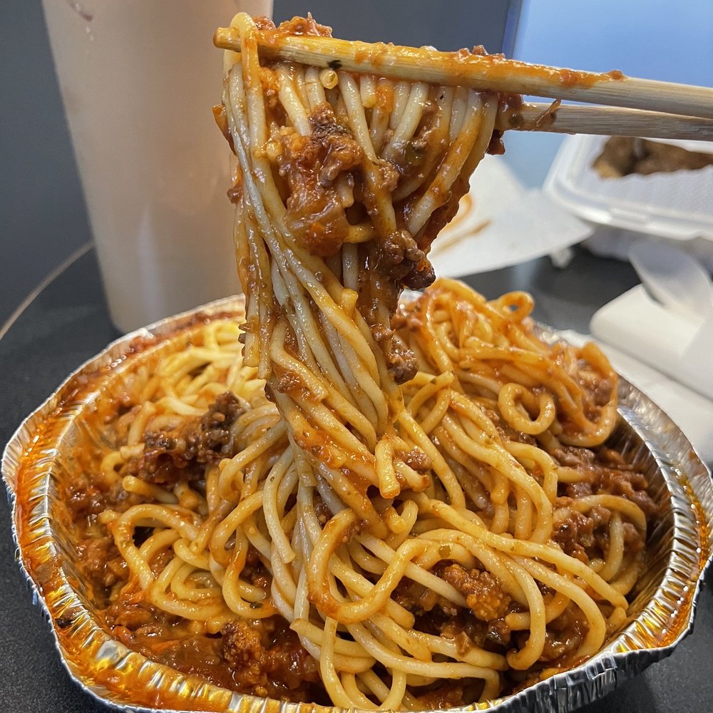spaghetti being lifted by chopsticks