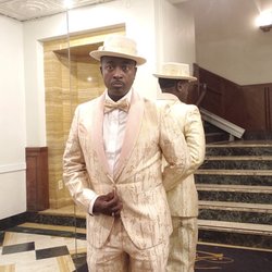 Zilas - Tailored suit, bow tie, hat, and shoes.