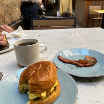 Outro - Greenwich Sandwich (egg, avocado, pesto on brioche) w side of Applewood Smoked Bacon - Cafes Near Me - New York, New York