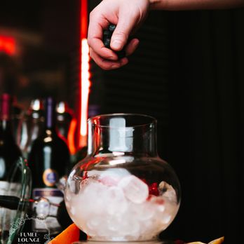 Fumee Lounge - a person pouring a drink into a glass - Hookah Bars Near Me - Miami, Florida Fumee Lounge - a person pouring a drink into a glass - Hookah Bars Near Me - Miami, Florida