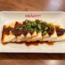 Mian - Silky tofu topped with our signature dual-pepper sauce, delivering bold, savory flavors, rich aroma, and a spicy kick.