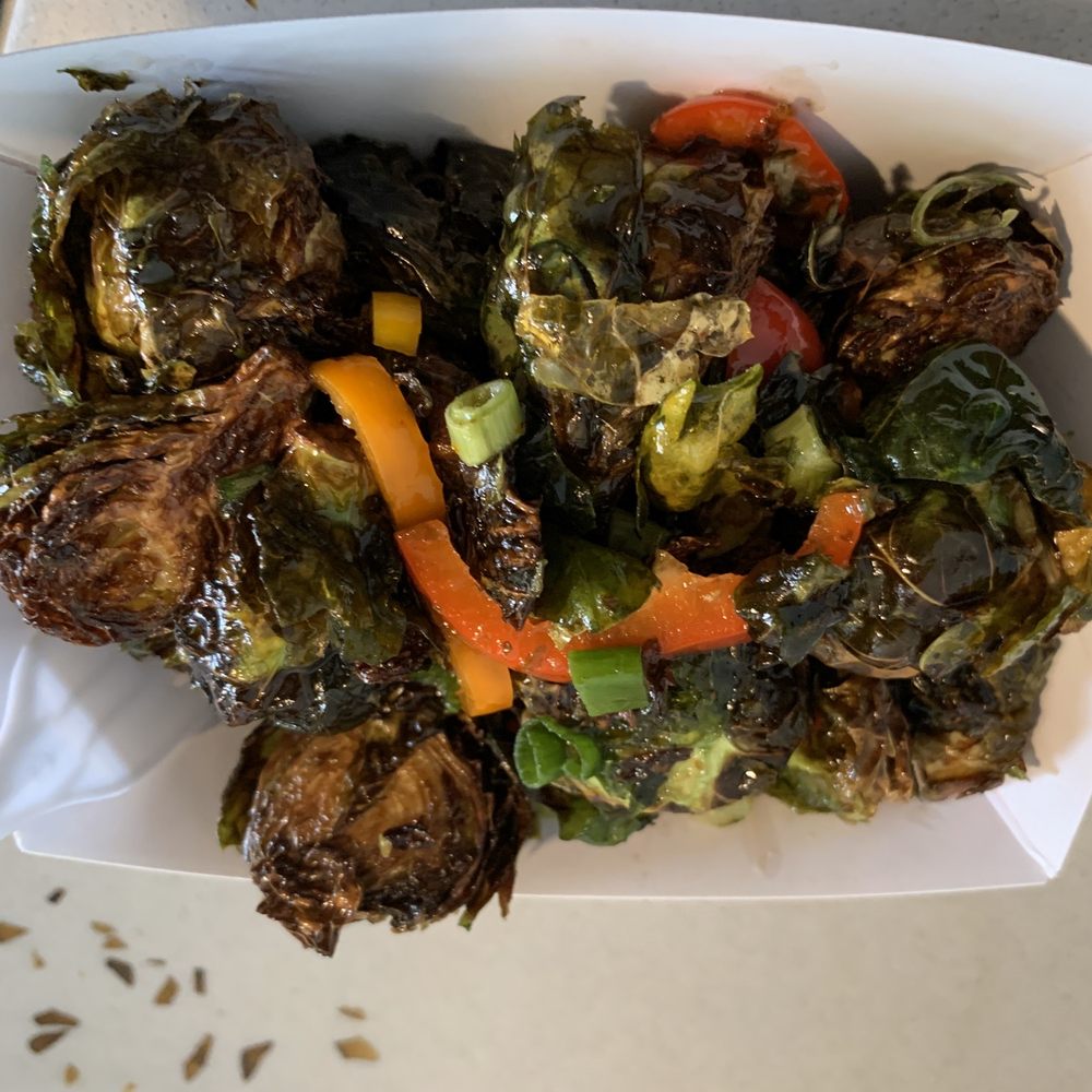 brussels sprouts and peppers in a paper container