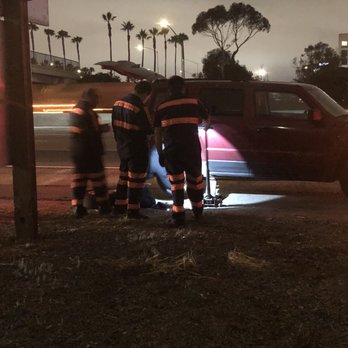 Hadley Tow - 4 men from a Hadley tow company trying to figure out how to change a simple tire - Towing Near Me - Costa Mesa, California