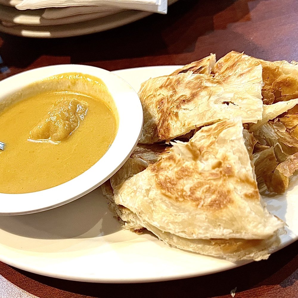 Malay Satay Hut - Roti canai: flaky layered crepe (like a Taiwanese scallion pancake) with a gentle curry is a great small appetizer. $4.95. 5* - Malaysian Near Me - Bellevue, Washington Malay Satay Hut - Roti canai: flaky layered crepe (like a Taiwanese scallion pancake) with a gentle curry is a great small appetizer. $4.95. 5* - Malaysian Near Me - Bellevue, Washington