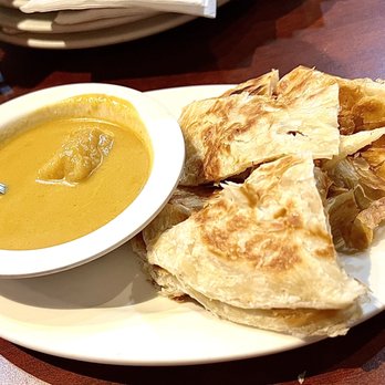 Malay Satay Hut - Roti canai: flaky layered crepe (like a Taiwanese scallion pancake) with a gentle curry is a great small appetizer.  $4.95.    5* - Malaysian Near Me - Bellevue, Washington