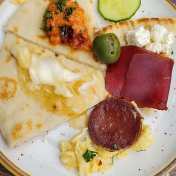 Lokma - Pita, honey butter, pasturma eggs with sajuk, kaymak and honey fruits cucumbers veggies hummus - Mediterranean Near Me - San Francisco, California