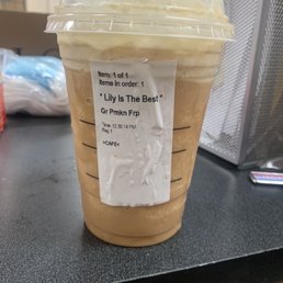 a cup of iced coffee on a counter a cup of iced coffee on a counter