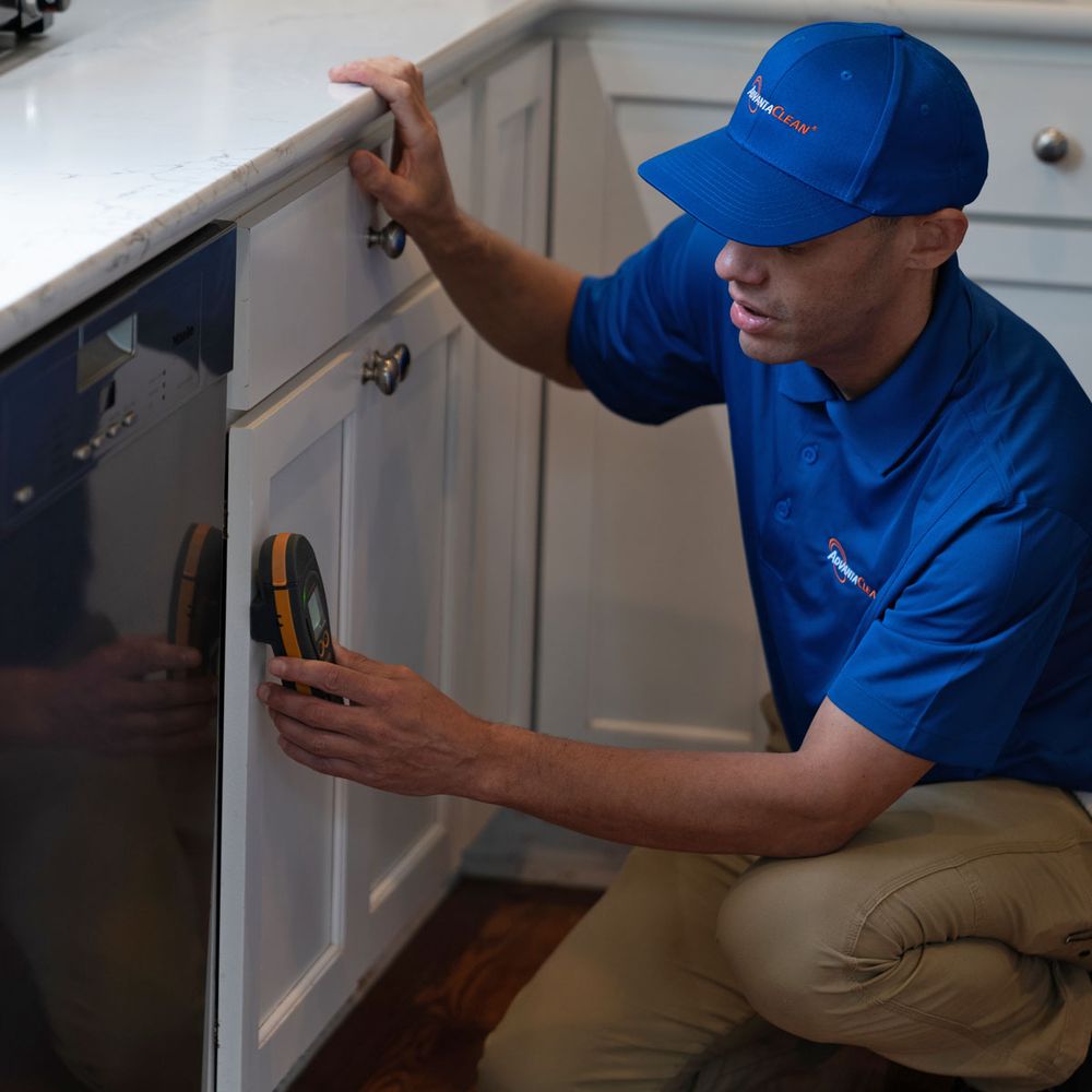 Technician working on a dishwasher.