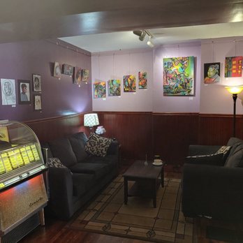 Donkey Coffee & Espresso - A sitting area with great pieces of art and and a juke box for some soft jams. - Coffee & Tea Near Me - Athens, Ohio