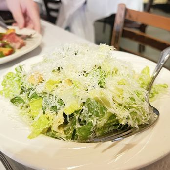 Enzo's - HOUSE SALAD mix of romaine and iceberg lettuce with tomatoes and red onions, house vinaigrette. - Italian Near Me - Bronx, New York Enzo's - HOUSE SALAD mix of romaine and iceberg lettuce with tomatoes and red onions, house vinaigrette. - Italian Near Me - Bronx, New York
