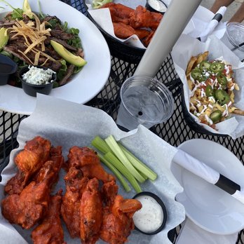 Sutherland's Food & Spirits - chicken wings, celery, and salad - Burgers Near Me - Chicago, Illinois Sutherland's Food & Spirits - chicken wings, celery, and salad - Burgers Near Me - Chicago, Illinois