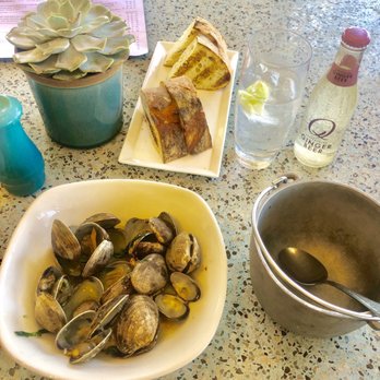 Terrazza - Bowl of steamed clams, toasted rustic bread and a chilled ginger drink - Italian Near Me - Santa Monica, California Terrazza - Bowl of steamed clams, toasted rustic bread and a chilled ginger drink - Italian Near Me - Santa Monica, California