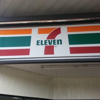 7-Eleven - a 7 - eleven sign on the side of a building - Convenience Stores Near Me - Orlando, Florida