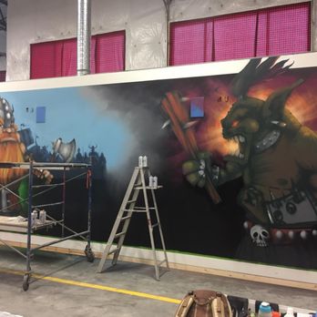 Axe Monkeys - Construction finishing touches on big mural wall. - Axe Throwing Near Me - Kelowna, British Columbia