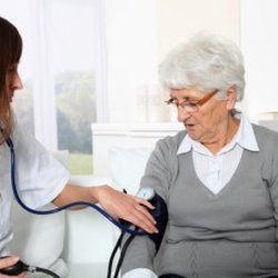 Guardian Home Care - Nurse checking BP of elderly lady
