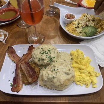 Ruby Slipper Uptown - Cranberry Mimosa and Biscuits & Gravy (comes with bacon, a fried green tomato and eggs) - Cafes Near Me - New Orleans, Louisiana