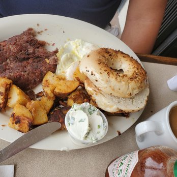 Roasters 'N Toasters - Pinecrest - Cornbeef and Hash with House Potatoes, Fried Eggs, Onion Bagel with Chive Cream Cheese. Amazing!!! - Bagels Near Me - Miami, Florida