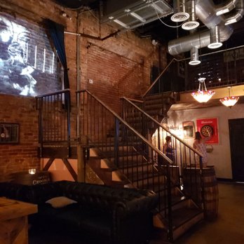 The Blind Elephant - Old movie projected on the exposed brick wall. Totally adds to the vibe!! - Lounges Near Me - Wilmington, North Carolina The Blind Elephant - Old movie projected on the exposed brick wall. Totally adds to the vibe!! - Lounges Near Me - Wilmington, North Carolina
