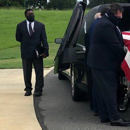 Tholley Taylor (Black COVID-mask, closest to hearse) aiding the family pallbearers.