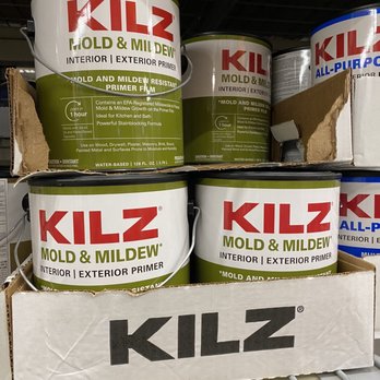 The Home Depot - Primer. - Multiple cans of KILZ Mold & Mildew Primer are displayed on a store shelf, with a cardboard box holding some of the cans. - Hardware Stores Near Me - Providence, Rhode Island