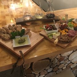 WineDown Walker - Our Bread board with homemade Parm oregano caper dip and the full Charcuterie board along with a flight of 3 different wines.